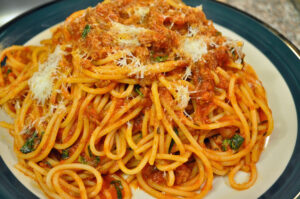 Prepared sauce over spaghetti