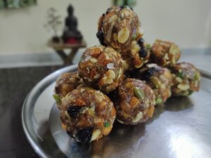 Prepared dry fruit laddu on a silver plate